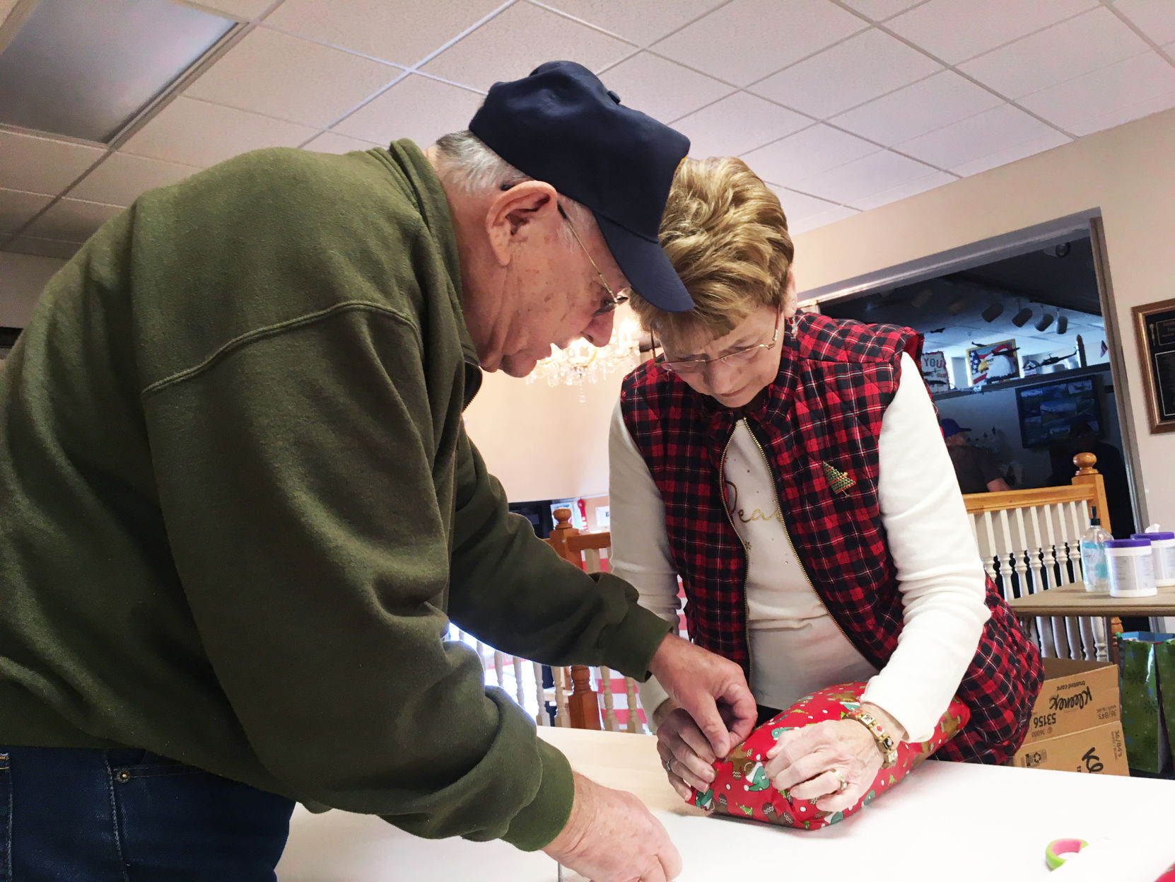 Ken and Karen Smars wrap a gift for holiday delivery to veterans home